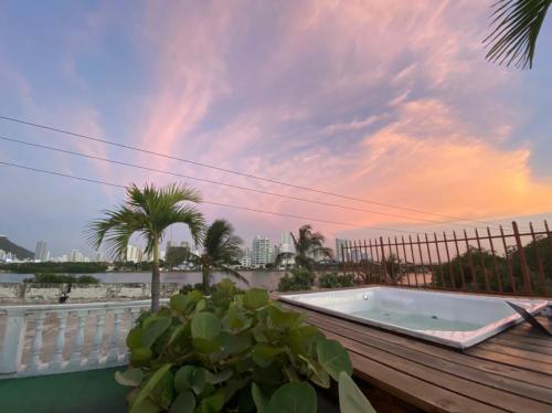 a hot tub on a deck with a palm tree at Patio de Getsemani in Cartagena de Indias