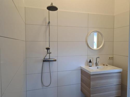 a bathroom with a shower and a sink at Ferienhaus Fam. Mersmann in Papenburg