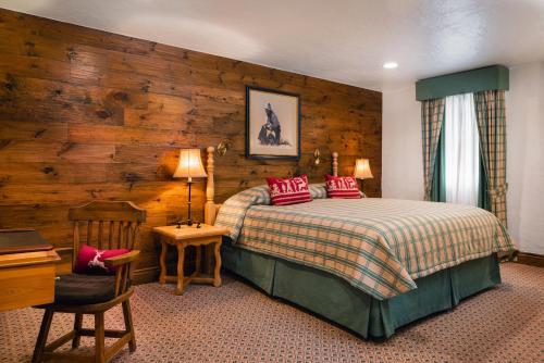 a bedroom with a bed and a wooden wall at Sonnenalp in Vail