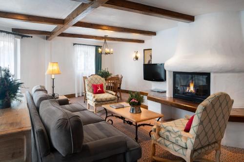 a living room with a couch and a fireplace at Sonnenalp in Vail