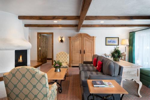 a living room with a couch and a fireplace at Sonnenalp in Vail
