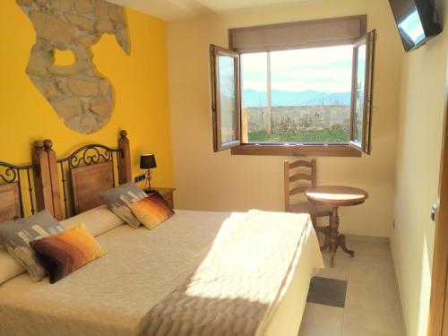 a bedroom with a bed and a window with a view at Iturritxo Landetxea in Donostia-San Sebastián