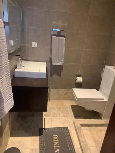 a bathroom with a sink and a toilet at WATERFRONT HOUSE 3 BEDROOM in Sere Kunda