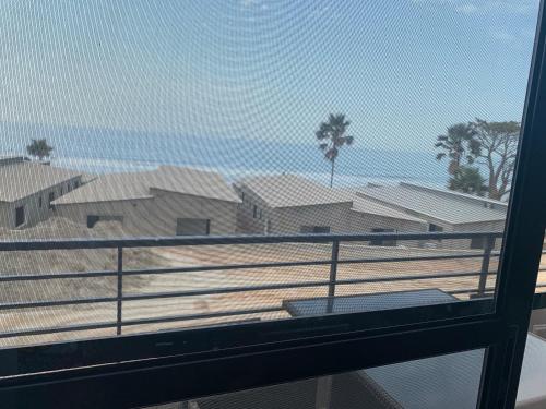 a view of the beach from a balcony at WATERFRONT HOUSE 3 BEDROOM in Sere Kunda