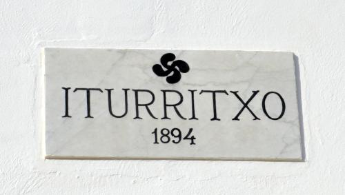 a sign with the name of the chemical element trinity at Iturritxo Landetxea in Donostia-San Sebastián