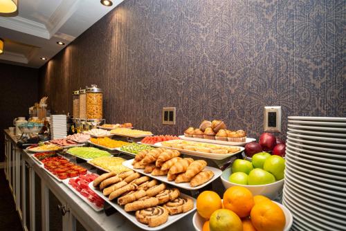 a buffet line with many different types of food at Sandman Signature Edmonton Downtown Hotel in Edmonton