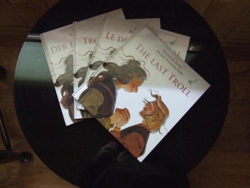 a book with a picture of a girl on it at Fossatún Sunset Cottage in Fossatún