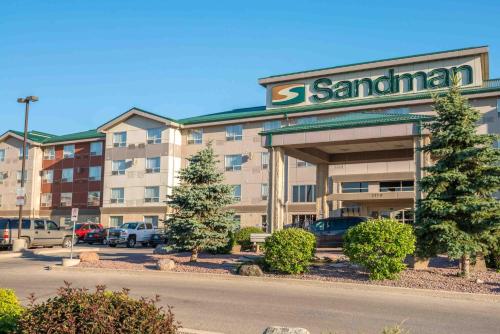 a santa ana hotel with cars parked in a parking lot at Sandman Hotel & Suites Winnipeg Airport in Winnipeg