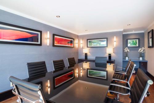 a meeting room with a table and chairs at Sandman Hotel & Suites Winnipeg Airport in Winnipeg