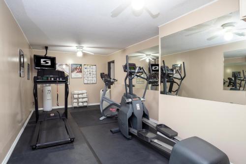 a gym with two tread machines and a mirror at Sandman Hotel Castlegar in Castlegar
