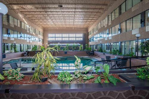 a large building with a pool and plants in it at Sandman Hotel Castlegar in Castlegar