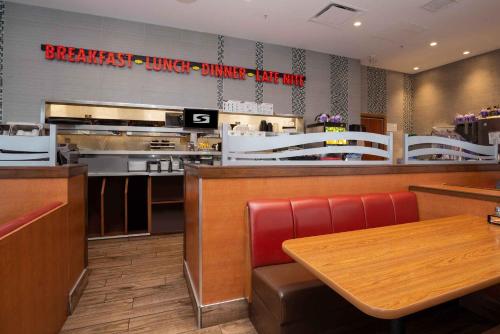 a fast food restaurant with a table and a counter at Sandman Hotel & Suites Calgary South in Calgary
