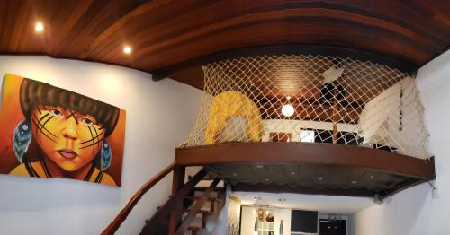 a staircase in a room with a painting on the wall at Flat 14 Pipa in Pipa