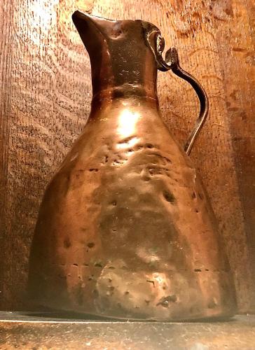 an old jug is sitting on a shelf at String Of Horses in Carlisle
