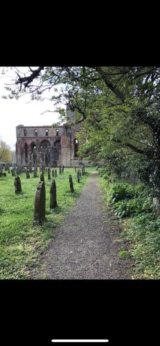 a grave yard with a building in the background at String Of Horses in Carlisle