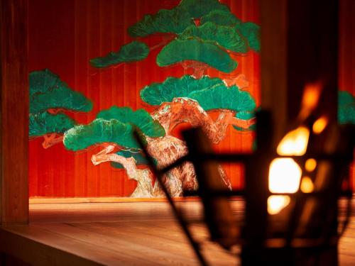 a figurine of a bonsai tree on a window at Yamatoya Honten in Matsuyama