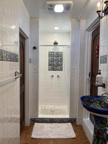 a bathroom with a shower and a blue sink at Private Room w/ Private Full Bathroom & WIFI & AC & Shared Kitchen in Los Angeles in Los Angeles