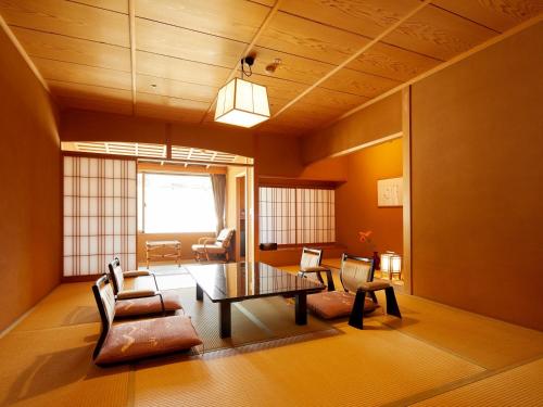a living room with a couch and a table at Yamatoya Honten in Matsuyama