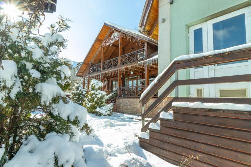a house with snow on the steps of it at Laguna in Slavske
