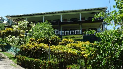 a house with a sign that reads grand applegate at Hotel Arboleda in Quepos