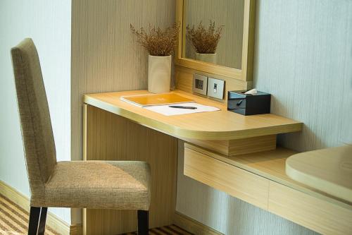 a desk with a chair and a mirror at Muong Thanh Luxury Vientiane Hotel in Vientiane