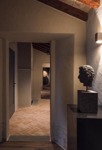 a museum with a bust on a table in a hallway at Rastrello in Panicale