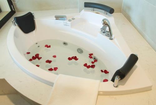 a bath tub filled with red hearts in it at Muong Thanh Luxury Vientiane Hotel in Vientiane