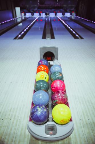 a row of bowling lanes with balls in the lanes at Magnum in Berehove