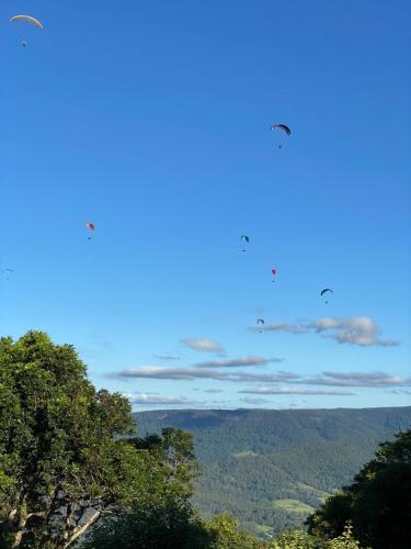 two birds flying in the sky over the mountains at Willow Cabin in Beechmont