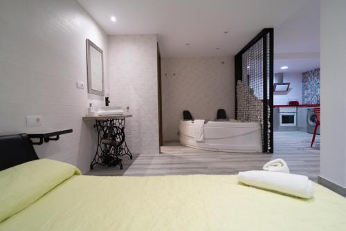 a bedroom with a tub and a bed and a bathroom at ROMANTICA in Anna