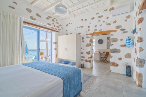 a bedroom with a bed and a large window at Veranta Luxury Suite in Hora Sfakion