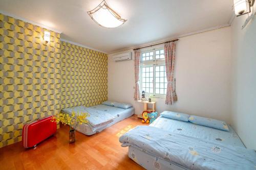 Una cama o camas en una habitación de Yilan Real Fun Homestay