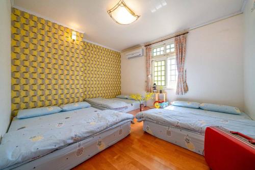 Una cama o camas en una habitación de Yilan Real Fun Homestay