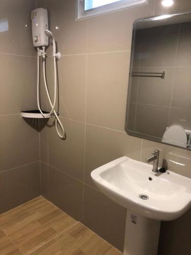 a bathroom with a sink and a mirror at Neo Hotel in Khon Kaen