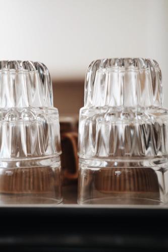 two empty glasses sitting on top of a table at Belly Inn Douliu in Douliu
