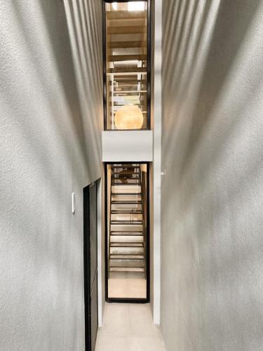 a hallway leading into a building with a door and a curtain at Belly Inn Douliu in Douliu
