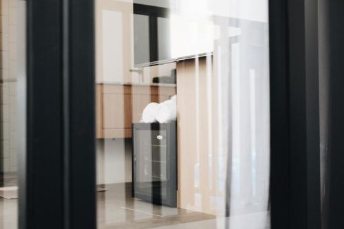 a glass door with a trash can in a room at Belly Inn Douliu in Douliu