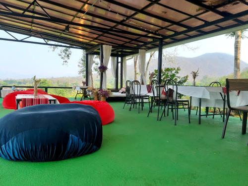 拜縣的住宿－拜縣常山度假村，一组桌子和椅子,位于绿色的地板上