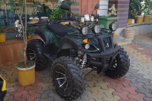 a green dirt bike parked next to a plant at Relax Adventure Resort in Igatpuri