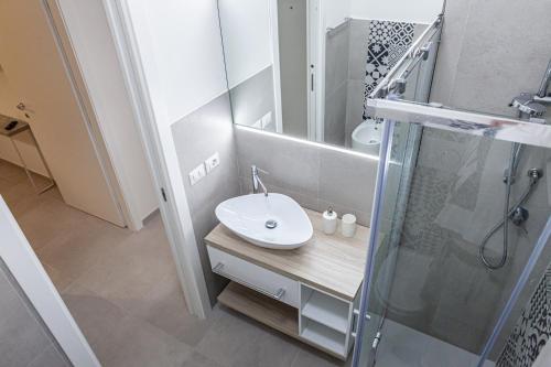 a bathroom with a sink and a shower at Marina in Brolo