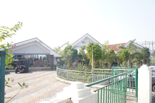 a house with a green gate in front of it at Relax Adventure Resort in Igatpuri