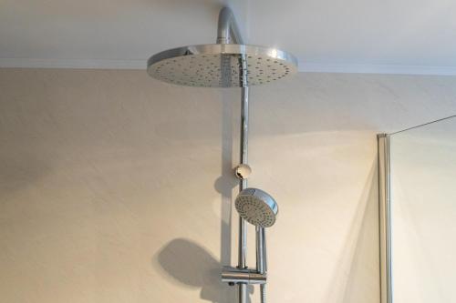 a metal light fixture hanging from a ceiling at Huis Ter Geul in Valkenburg