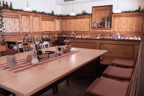 a large kitchen with wooden cabinets and a large table at Gasthof Kampenwand Aschau in Aschau im Chiemgau