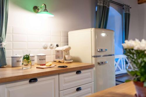 a kitchen with a counter with a white refrigerator at Selské stavení Melchior Häusler in Šonov