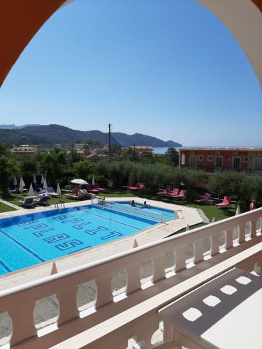 a view of a swimming pool from a balcony at Eleni Apartments in Arillas