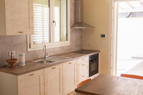 a kitchen with a sink and a stove at La Spiaggetta in Torre San Giovanni Ugento