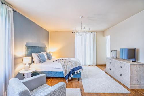 a bedroom with a bed and a tv and a couch at Cascina Bo in Canelli