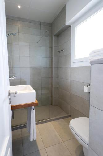 a bathroom with a sink and a shower at Hostal La Palma in Fornells