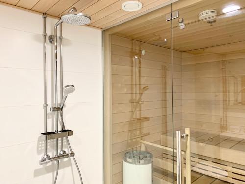 a shower with a glass door in a bathroom at City Home Finland Big Luxury Suite - Spacious Suite with Own SAUNA, One Bedroom and Furnished Balcony next to Train Station in Tampere