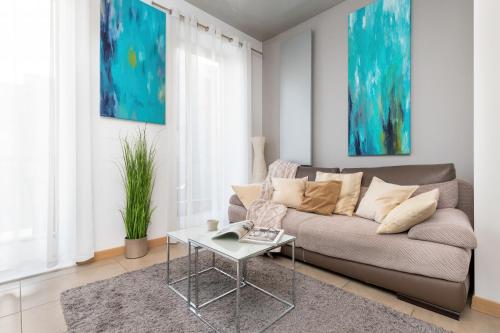 a living room with a couch and a table at Old Town Neptun Apartments by Renters in Gdańsk